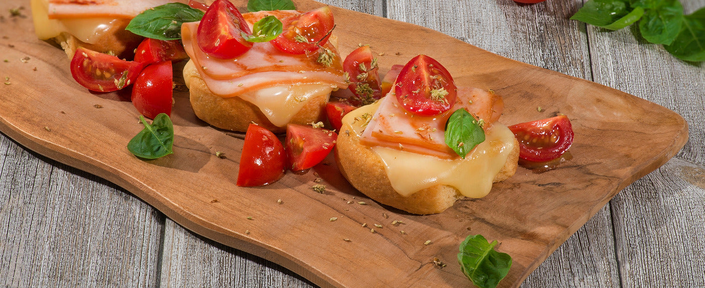 Small olive oil rusks toasted with turkey and cheese 3 “the Manna” small olive oil rusks, 2 slices of cheese, 2 slices of turkey, 5-6 cherry tomatoes, Oregano, Several basil leaves, tables spoons of olive oil, teaspoon of honey